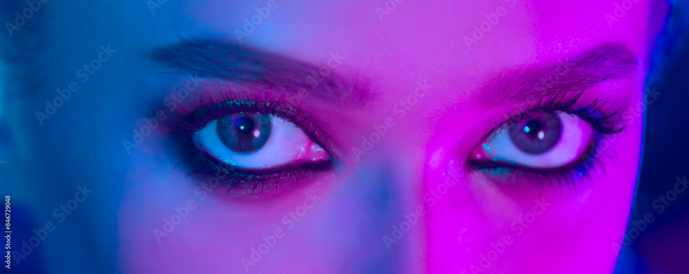A close-up view of a woman with striking blue eyes looking directly at the camera. Her eyes are the main focal point of the image, showcasing their vibrant color and intensity. A close-up view of a woman with striking blue eyes looking directly at the camera. Her eyes are the main focal point of the image, showcasing their vibrant color and intensity.