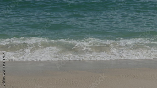 Serene Ocean Waves Gently Crashing on Sandy Shore