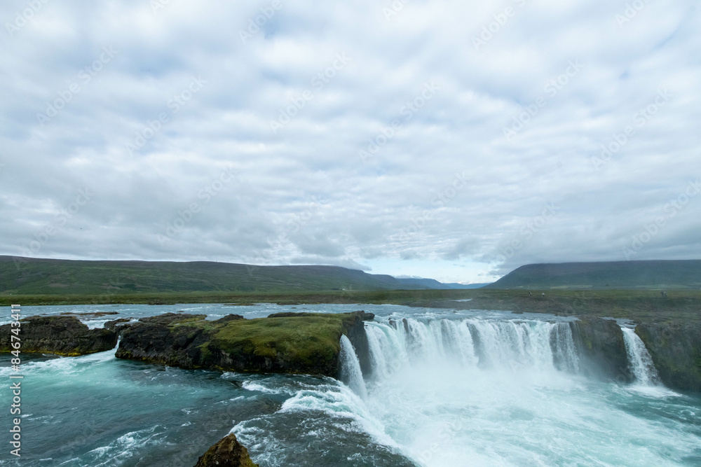 Iceland Akureyri landcape with waterfall on the river on a sunny day Iceland Akureyri landcape with waterfall on the river on a sunny day
