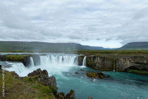 Icelandic landscape of the body of water, lakes and waterfall on a cloudy day from Akureyri
