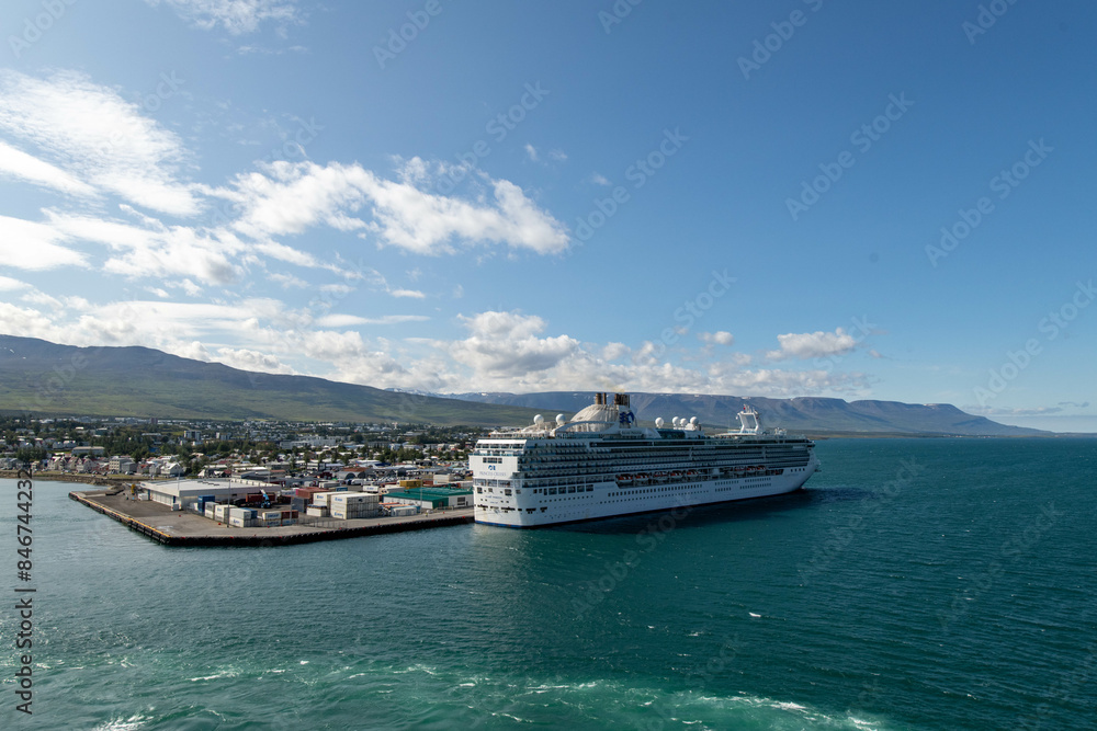 The view on the port of Akureyri from a cruise ship with a ship docked The view on the port of Akureyri from a cruise ship with a ship docked