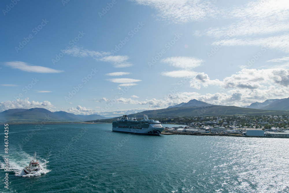 The view on the port of Akureyri from a cruise ship with a ship docked The view on the port of Akureyri from a cruise ship with a ship docked