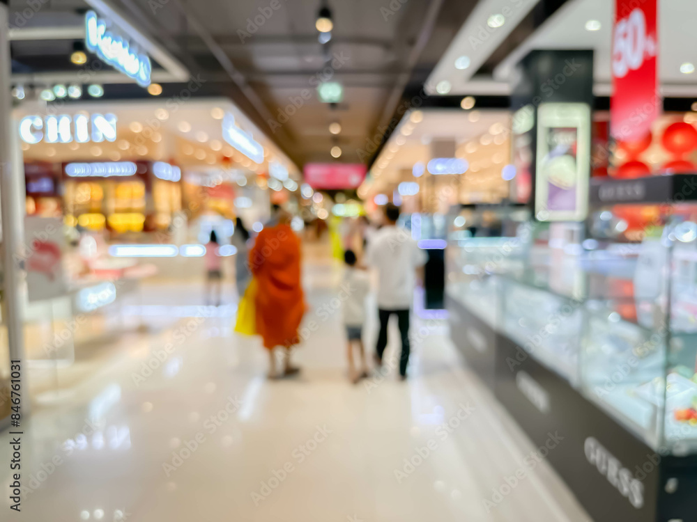 Blurred image of people walking and shoping at atmosphere of shopping in a leading shopping center decorated in a modern way. Blurred image of people walking and shoping at atmosphere of shopping in a leading shopping center decorated in a modern way.