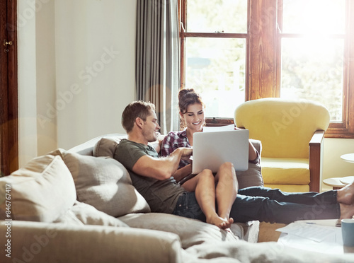 Photography Laptop, happy couple and talking on sofa for budget, planning and savings account for personal debt