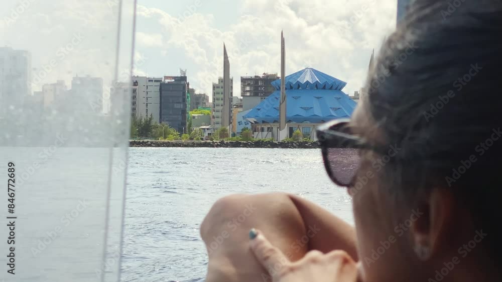 Male, Maldives - 14th may, 2024: caucasian woman tourist sit on public boat travel to Maldives island and enjoy capital coast panorama and King Salman mosque Male, Maldives - 14th may, 2024: caucasian woman tourist sit on public boat travel to Maldives island and enjoy capital coast panorama and King Salman mosque