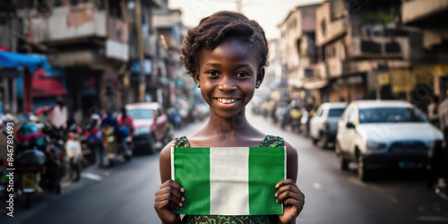 A Nigerian girl holding Nigeria flag in a Lagos street