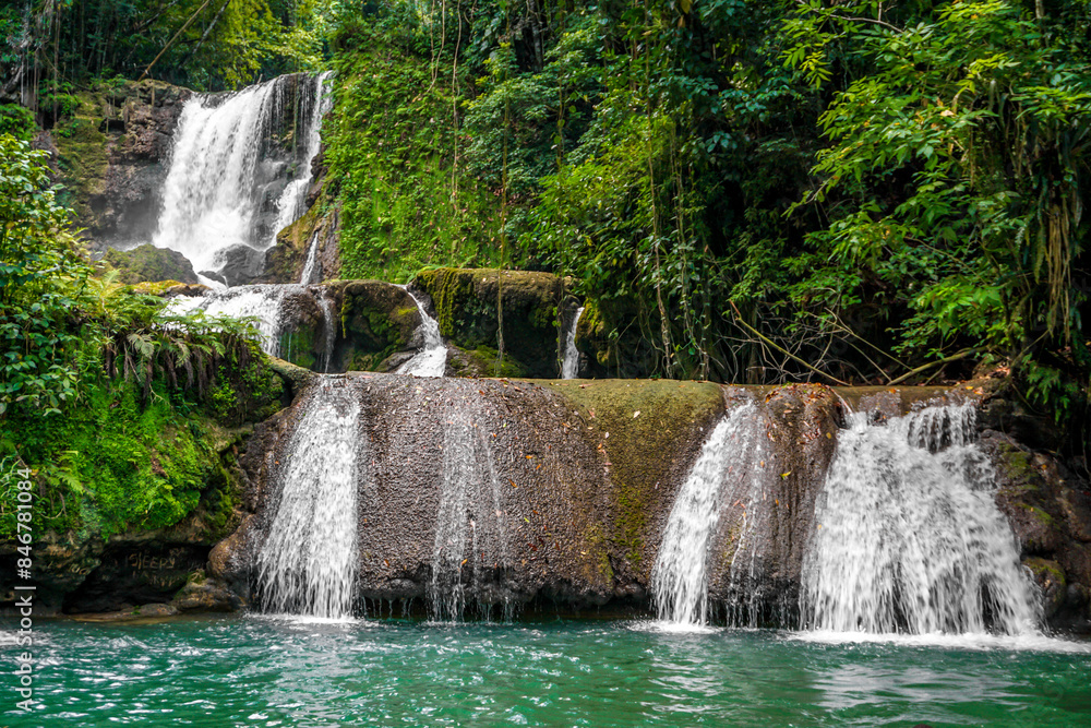 Fototapeta premium in Jamaica a set of 7 different height and difficulty waterfalls with plentiful of ziplining, swimming and enjoyment.