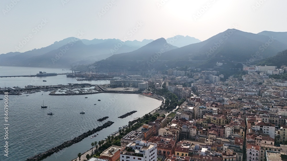 Fototapeta premium Salerno, in Campania, is famous for the stunning Amalfi Coast. It offers breathtaking views of the Tyrrhenian Sea, beautiful beaches, and a lively promenade, perfect for scenic walks