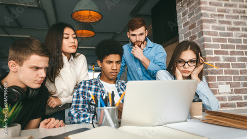 Wallpaper Mural Concentrated classmates doing their project at library together, looking at laptop Torontodigital.ca