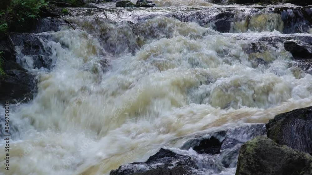 A dynamic view of a waterfall in a forest stream, showcasing the powerful and turbulent flow of water over rocks. Ideal for nature, adventure, and water themes. A dynamic view of a waterfall in a forest stream, showcasing the powerful and turbulent flow of water over rocks. Ideal for nature, adventure, and water themes.