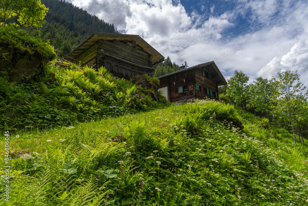 alpine houses on the edge of forest, wooden cabin next to the path, on the raodside, while hiking, we come across old alpine three stage farming huts, hiking in the mountains from Vorarlberg alpine houses on the edge of forest, wooden cabin next to the path, on the raodside, while hiking, we come across old alpine three stage farming huts, hiking in the mountains from Vorarlberg