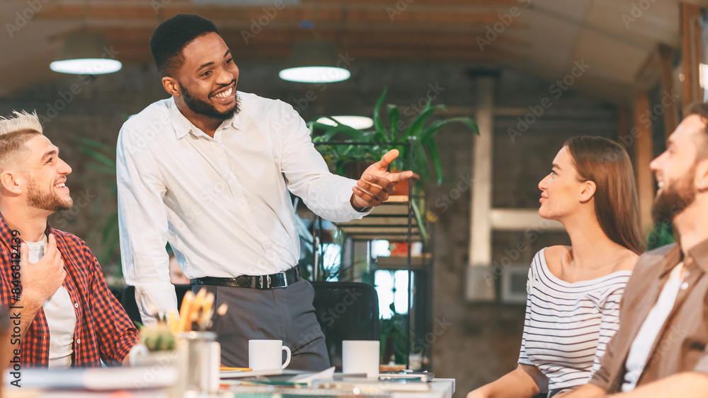 © Prostock-studio - Enthusiastic team members participate in a lively discussion during a friendly office meeting in a modern workspace.