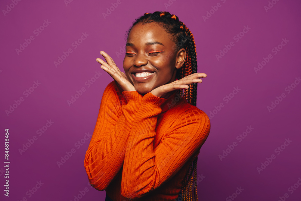 © Jacob Lund - Vibrant young woman with two tone braids celebrating on a colourful purple background