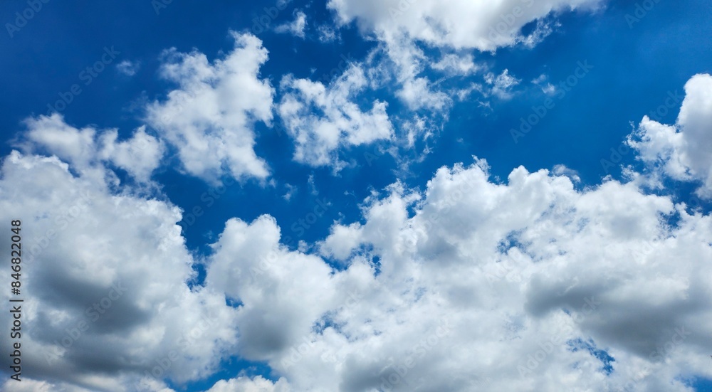 Obraz premium Blue sky with white clouds, bright colored cloudscape banner. Fluffy heaven pattern, aesthetic natural scene. Beautiful Cloudy background, nature environment wallpaper, panoramic view