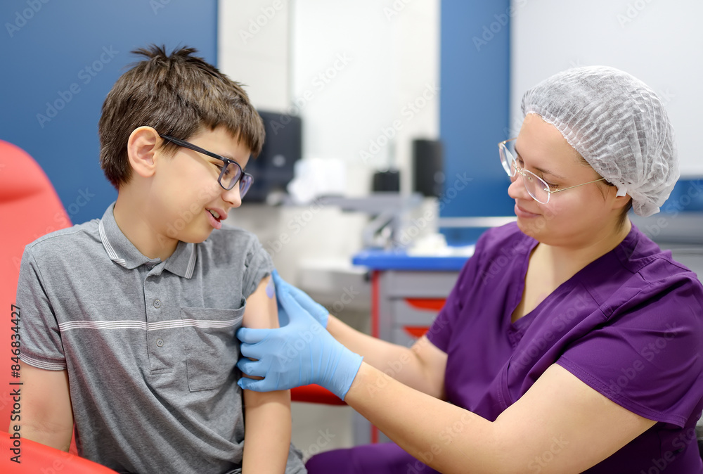 A little boy is being vaccinated. A child is very afraid of the injection. Schoolkid nervous during scheduled vaccination. Close up A little boy is being vaccinated. A child is very afraid of the injection. Schoolkid nervous during scheduled vaccination. Close up