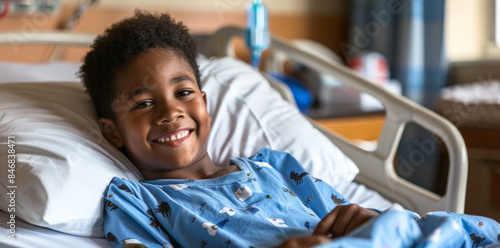 A young black patient finds comfort and joy in his hospital room as he smiles from his bed, surrounded by medical equipment and receiving top-notch healthcare
