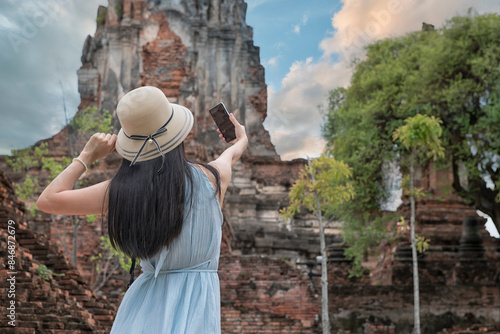 Beautiful woman  is travel on holiday in Ayutthaya, Thailand. People take a photo on Ayutthaya Historical Park, Thailand.