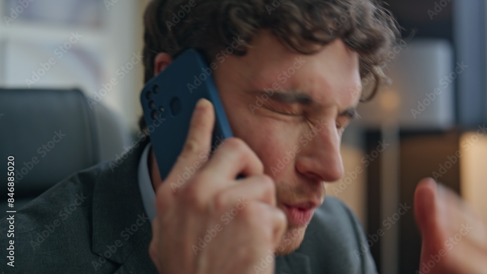 Mad man arguing mobile phone sitting office closeup. Businessman feeling angry