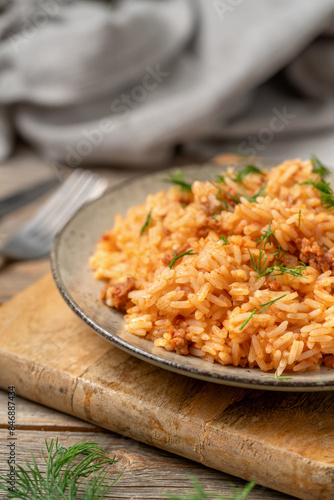 Rice with minced beef in tomato sauce in a plate closeup
