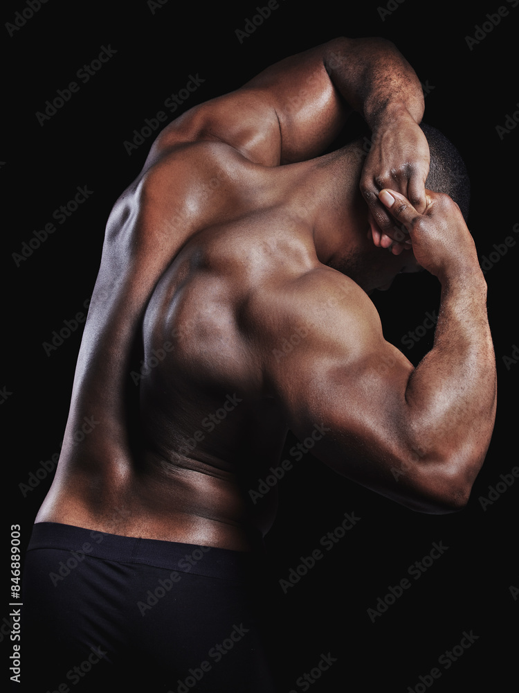 Fototapeta premium Flexing, body and African man with back muscle for exercise, workout goal and sports training in studio. Male person, skin and strong athlete for bodybuilder competition and power by black background