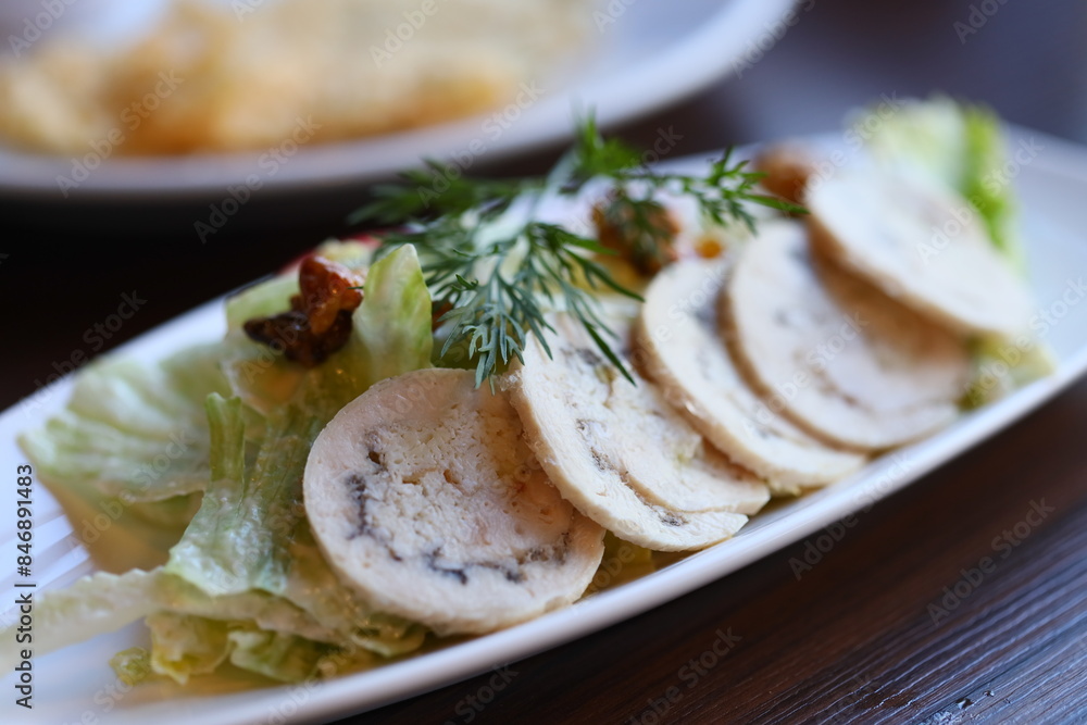 A white plate topped with lettuce and slices of meat. Perfect for food blogs or restaurant menus. A white plate topped with lettuce and slices of meat. Perfect for food blogs or restaurant menus.