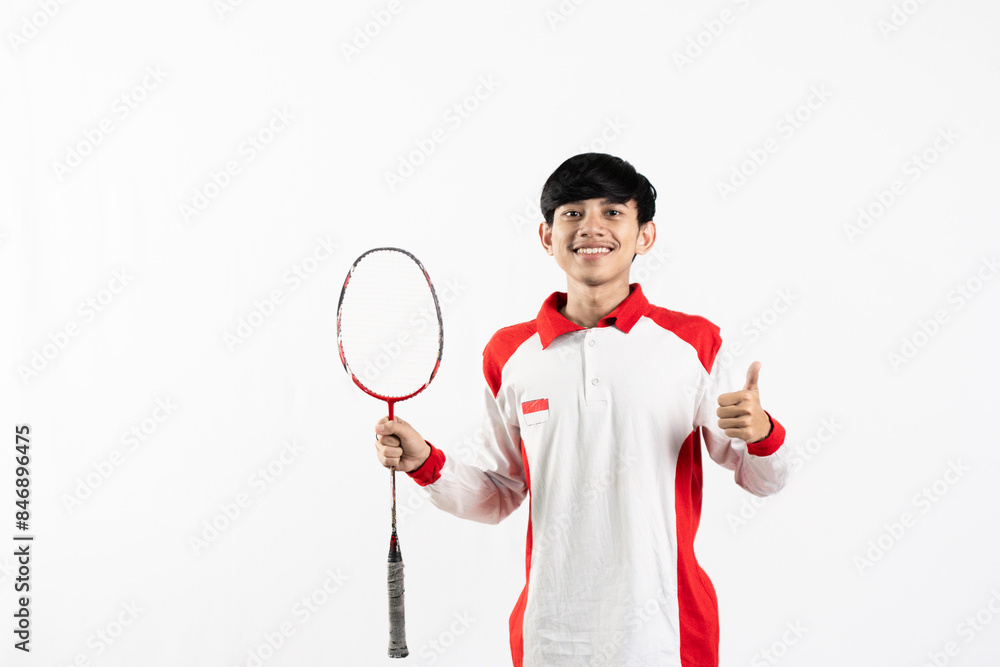 Young Asian man wearing Indonesian clothing is holding a racket and playing badminton. isolated white background Young Asian man wearing Indonesian clothing is holding a racket and playing badminton. isolated white background