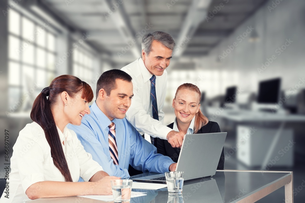 Happy business people discussing project in office Happy business people discussing project in office