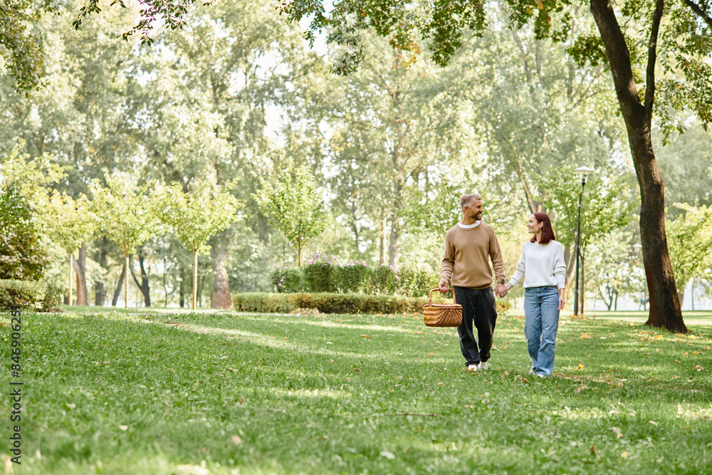 A loving couple in casual attire leisurely walking through a serene park. A loving couple in casual attire leisurely walking through a serene park.