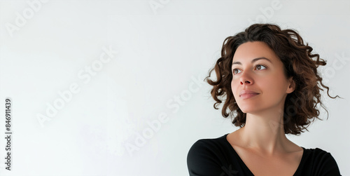 A woman with curly hair is looking up at the camera. She has a serious expression on her face