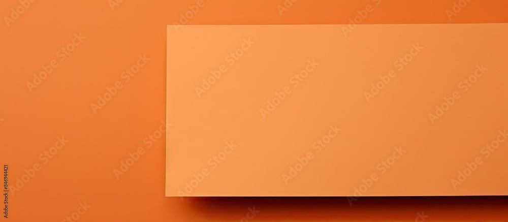 Orange square shape on wall with a distinct shadow beneath. with copy space image. Place for adding text or design Orange square shape on wall with a distinct shadow beneath. with copy space image. Place for adding text or design