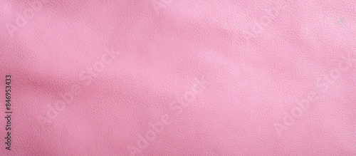 Close-up photo of a textured pink leather background with a soft illumination, suitable for graphic design projects. with copy space image. Place for adding text or design