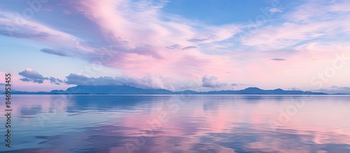 Tranquil lake reflects pink sky and clouds in a serene morning scene. with copy space image. Place for adding text or design
