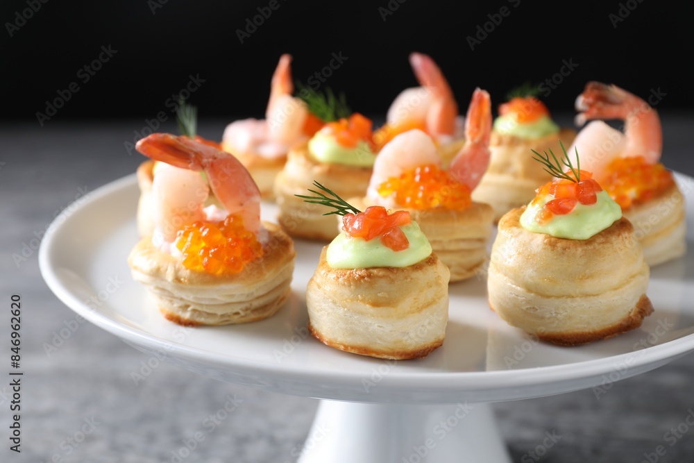 Different delicious puff pastry snacks on grey table Different delicious puff pastry snacks on grey table