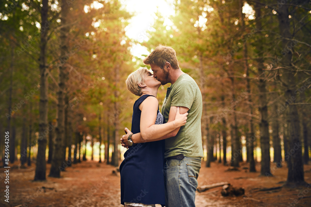 Couple, forest and happy with kiss for love with support, care and trust in Germany. People, relationship and affection in woods on holiday or vacation and travel for bonding, embrace and memories Couple, forest and happy with kiss for love with support, care and trust in Germany. People, relationship and affection in woods on holiday or vacation and travel for bonding, embrace and memories