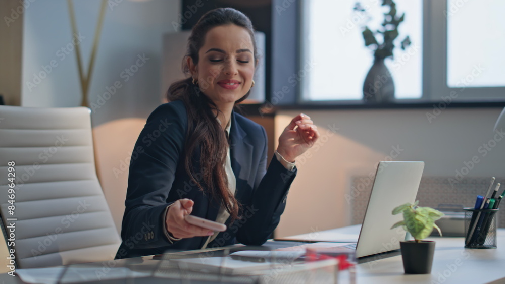 Smiling lady resting smartphone at luxury office closeup. Woman enjoying break Smiling lady resting smartphone at luxury office closeup. Woman enjoying break