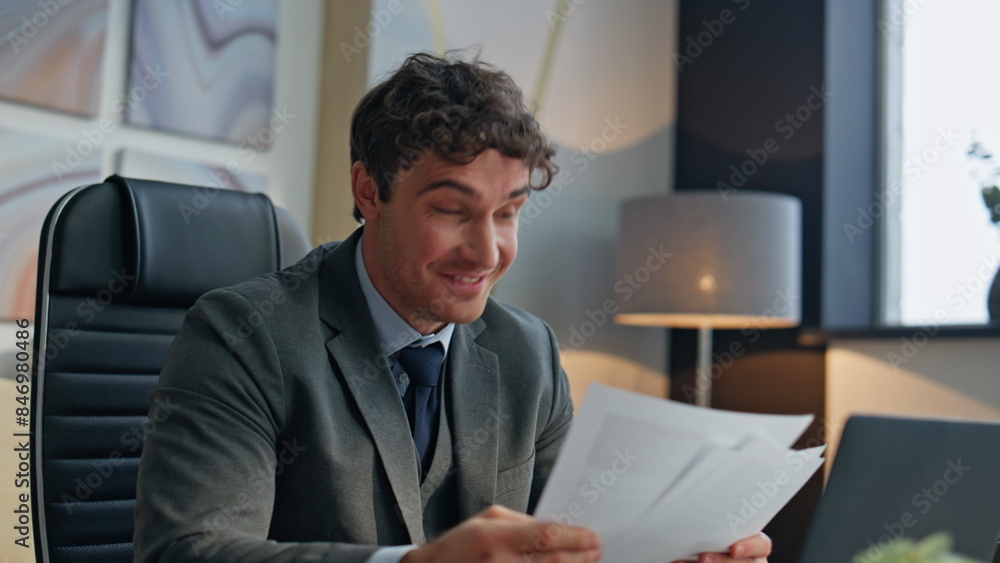Happy boss speaking web conference in office closeup. Smiling man showing papers Happy boss speaking web conference in office closeup. Smiling man showing papers