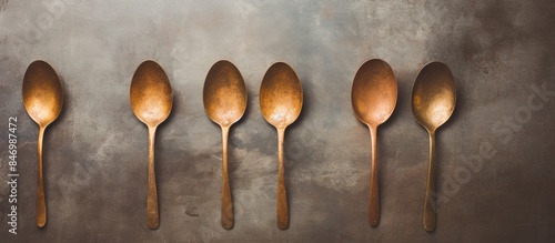 Five spoons are neatly arra...