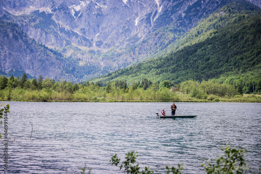 A beautiful view on the Ehrwalder Almsee and the Zugspitze on a sunny summer day in Austria, 2024, pescadores, haciendo su labor del dia para llevar comida a casa A beautiful view on the Ehrwalder Almsee and the Zugspitze on a sunny summer day in Austria, 2024, pescadores, haciendo su labor del dia para llevar comida a casa