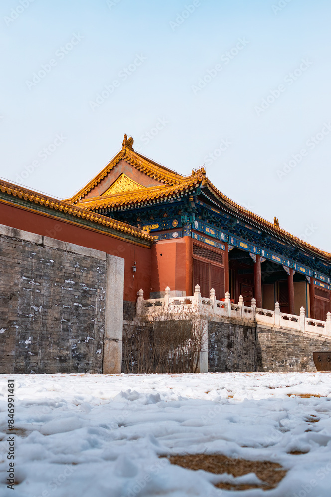 Fototapeta premium The Forbidden City, covered in snow on the ground in winter.
