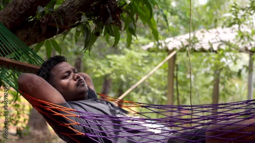 one man seating on tree zula for relaxing photo