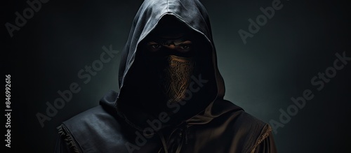 Hooded figure in black hood...