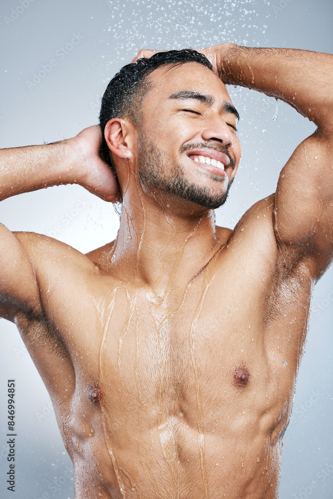 Man, water and shower on body for cleaning, skincare and wash on white studio background with smile. Male model, happiness and hygiene with clear liquid for facial, wellness and self care in bathroom Man, water and shower on body for cleaning, skincare and wash on white studio background with smile. Male model, happiness and hygiene with clear liquid for facial, wellness and self care in bathroom