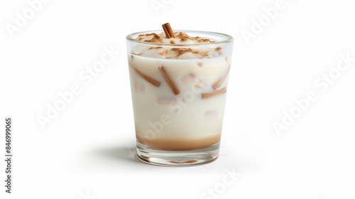 A glass of milk with cinnamon sticks in it