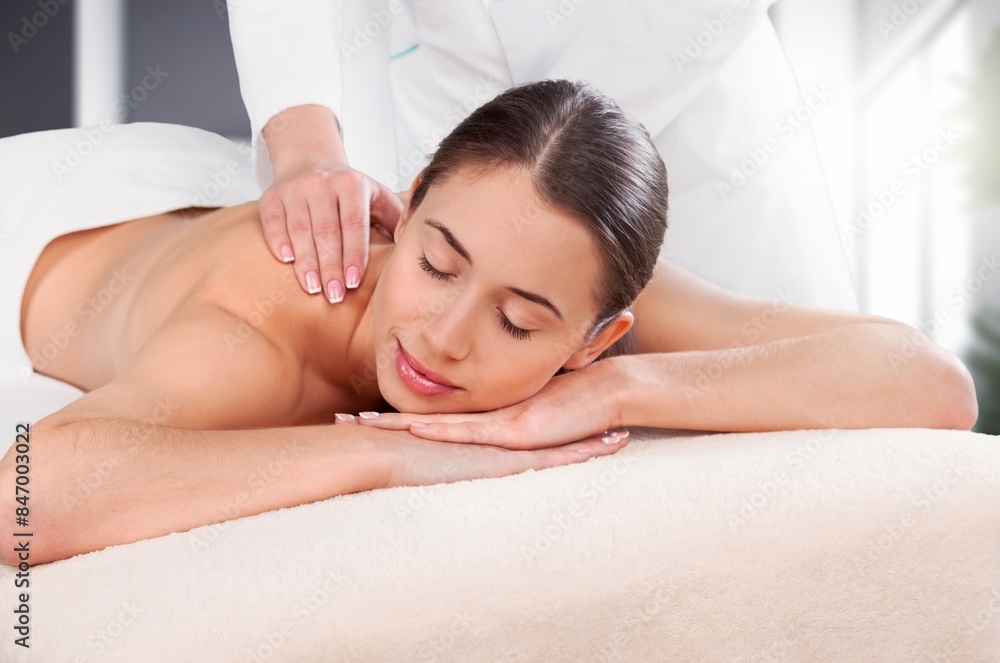 Young woman enjoying relaxing spa massage Young woman enjoying relaxing spa massage