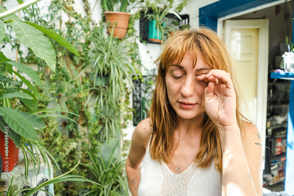 Woman covering her eye with her hand Woman covering her eye with her hand