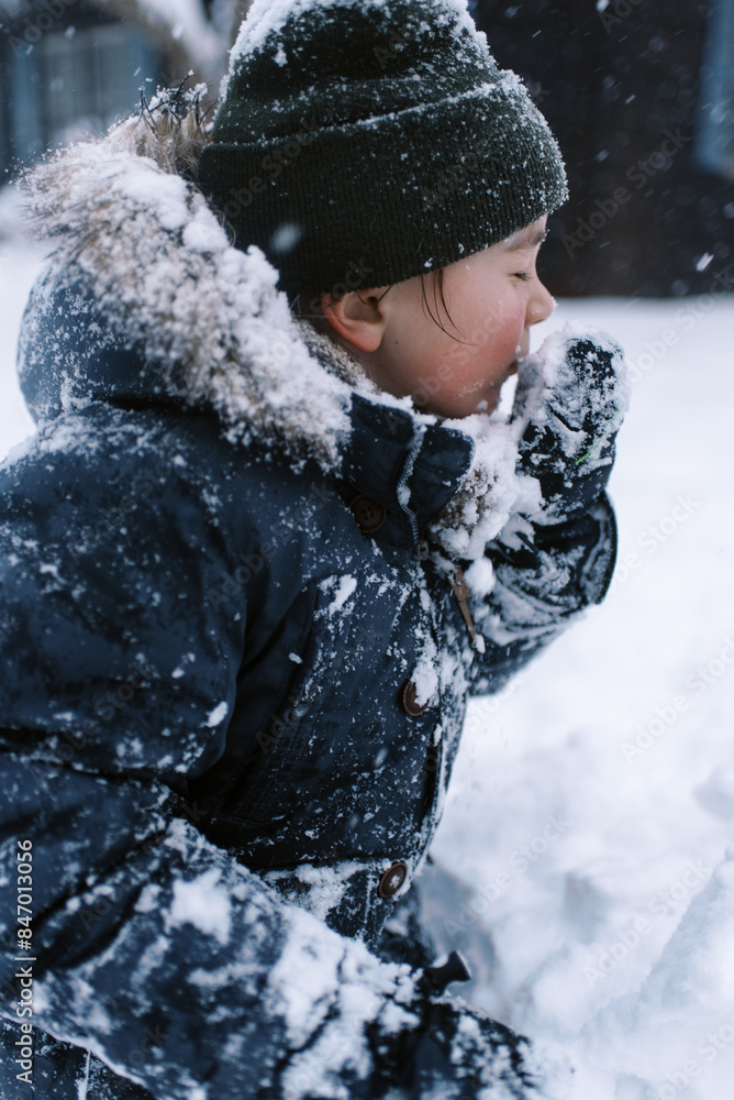 happy boy in winter clothing spending day in snow happy boy in winter clothing spending day in snow