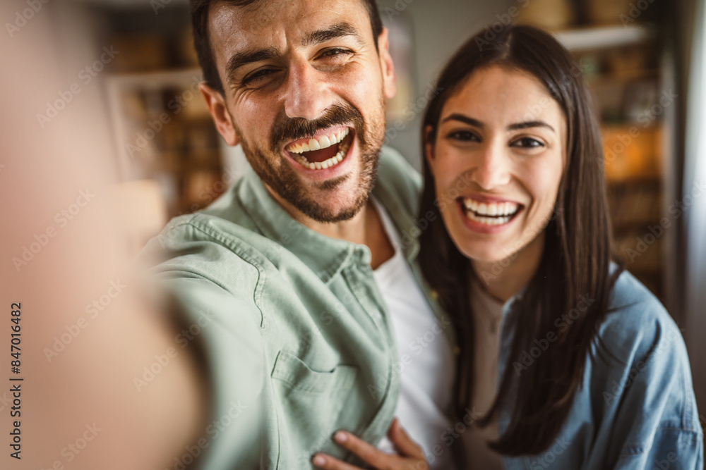 Adult young couple take a self portrait of their or have video call Adult young couple take a self portrait of their or have video call