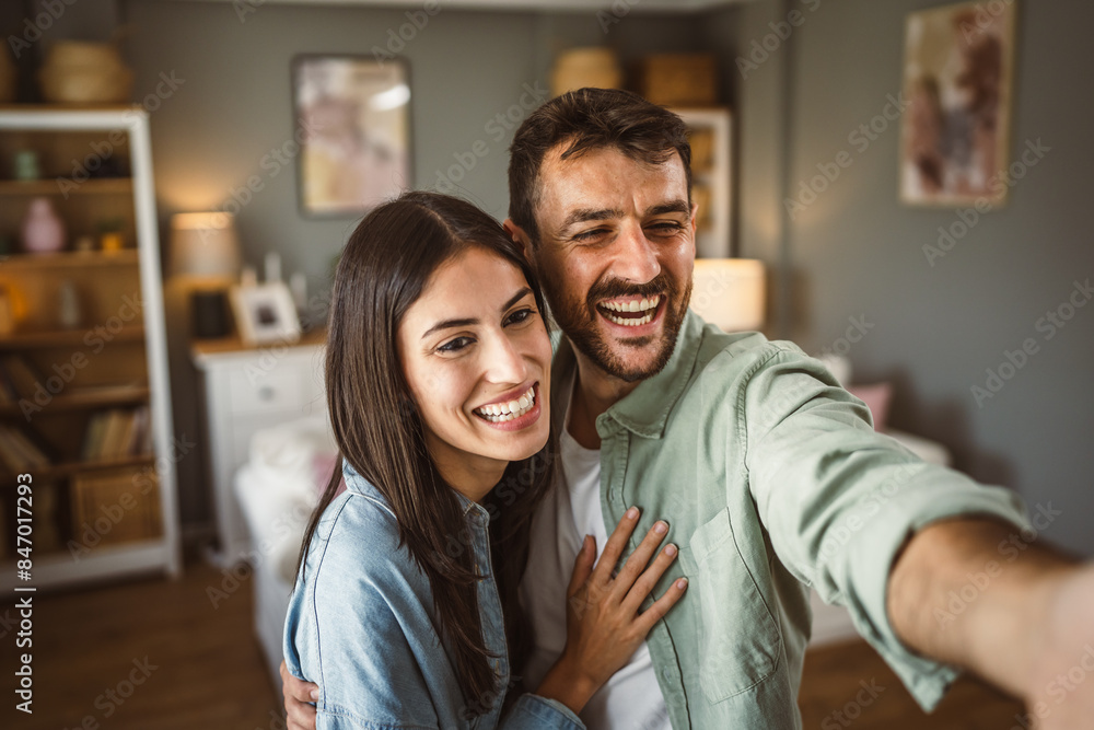 Adult young couple take a self portrait of their or have video call Adult young couple take a self portrait of their or have video call