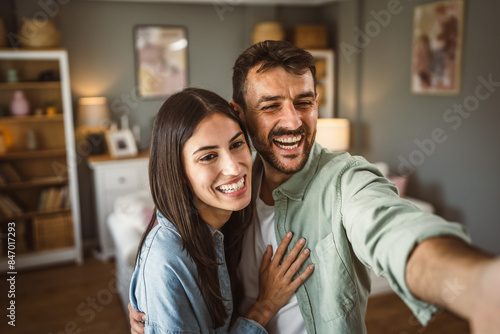 Adult young couple take a self portrait of their or have video call photo