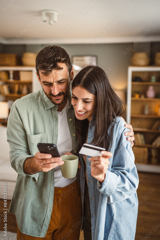 Couple and buy online on mobile phone with credit card at home Couple and buy online on mobile phone with credit card at home